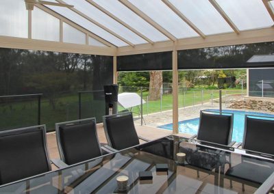 outdoor roller blinds next to a pool