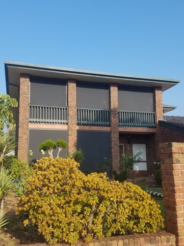 two story house with outdoor roller blinds