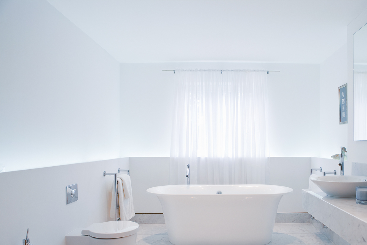 Sheer curtains installed in a bathroom.