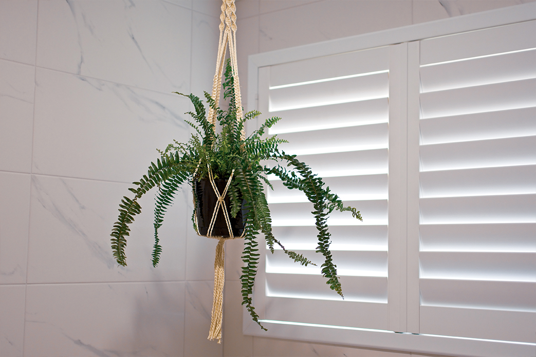 Plantation shutters installed in a bathroom.