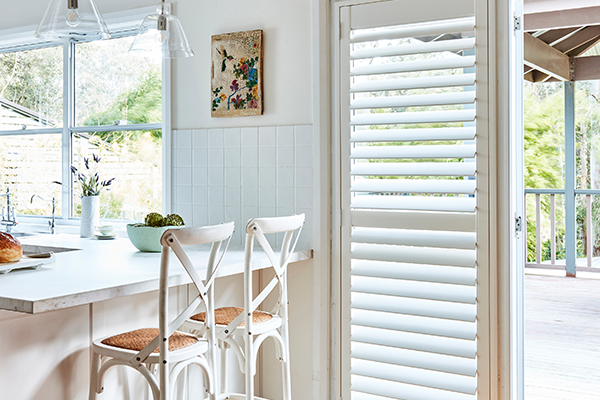 Dinning room with plantation shutters installed for a better control of light.